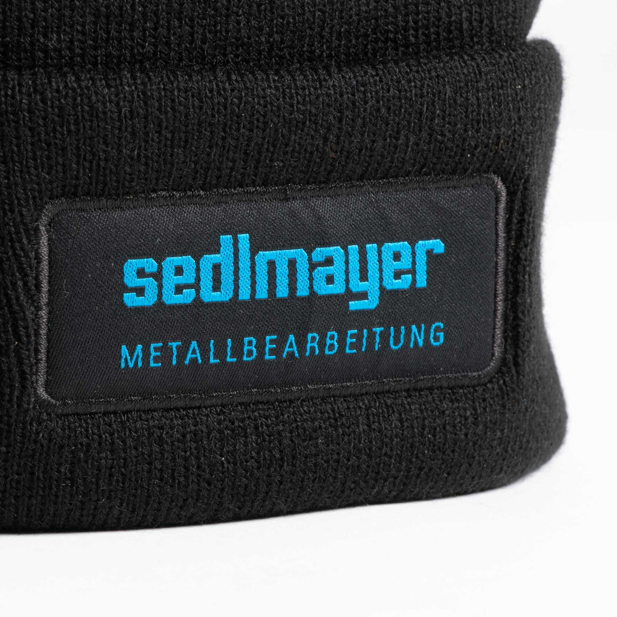 Strickmütze Schwarz (SEDLMAYER) – mit Logo besticken